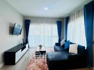 Spacious living room with modern decor and large windows for natural light.