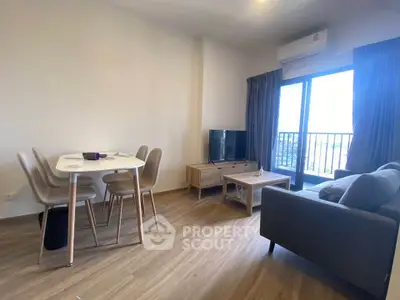 Modern living room with dining area and balcony view