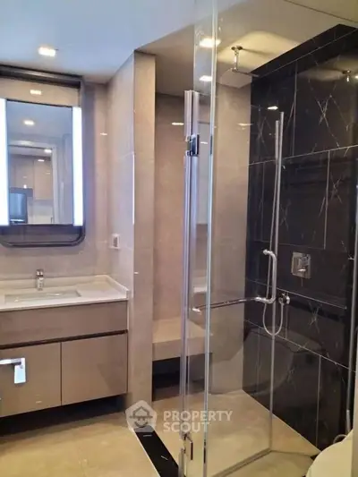 Modern bathroom with glass shower and sleek vanity