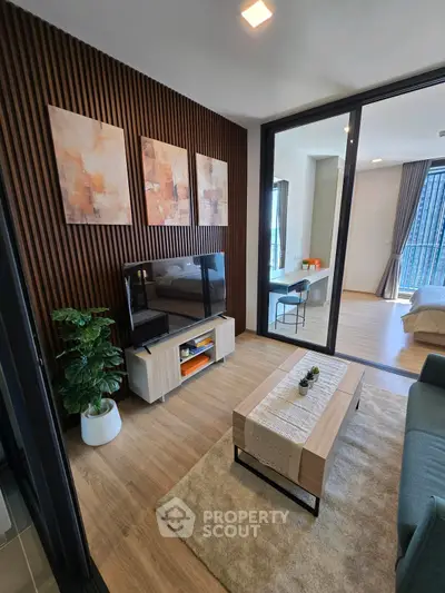 Modern living room with stylish decor and wooden accents in a contemporary apartment.