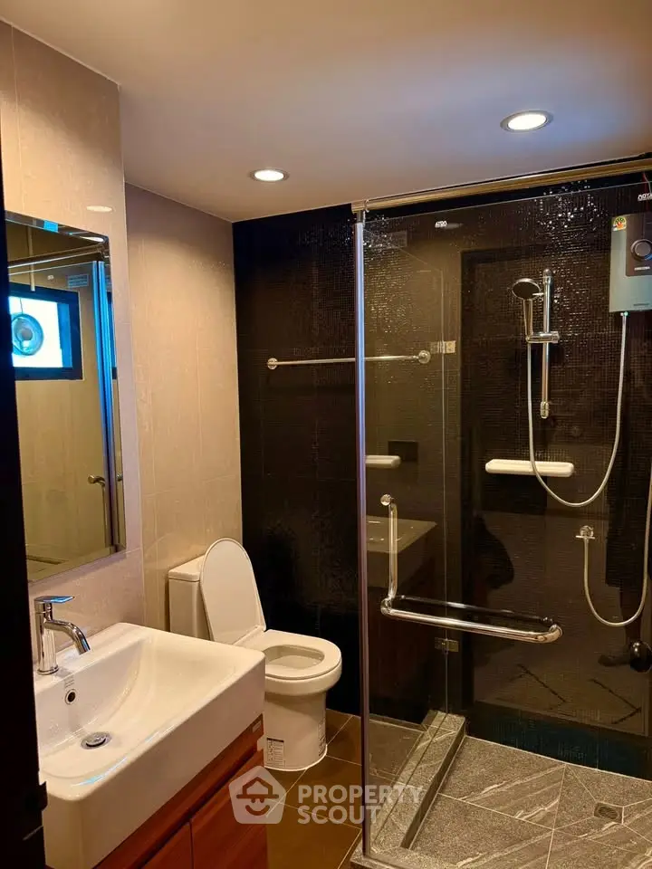 Modern bathroom with glass shower and sleek fixtures