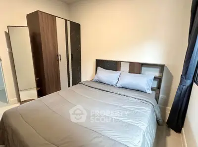 Cozy bedroom with modern furniture and natural light, perfect for relaxation and comfort.