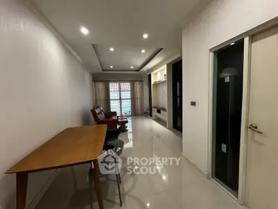 Spacious modern living room with sleek furniture and large windows for natural light.