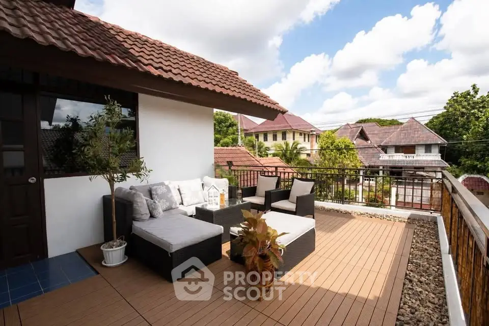 Charming rooftop terrace with cozy seating and scenic neighborhood view