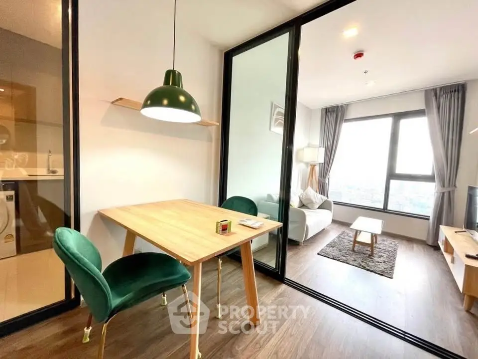 Modern living room with glass partition and city view, featuring stylish dining area and cozy seating.