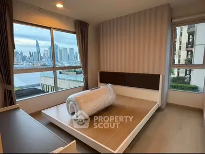 Modern bedroom with city skyline view, featuring large windows and minimalist design.