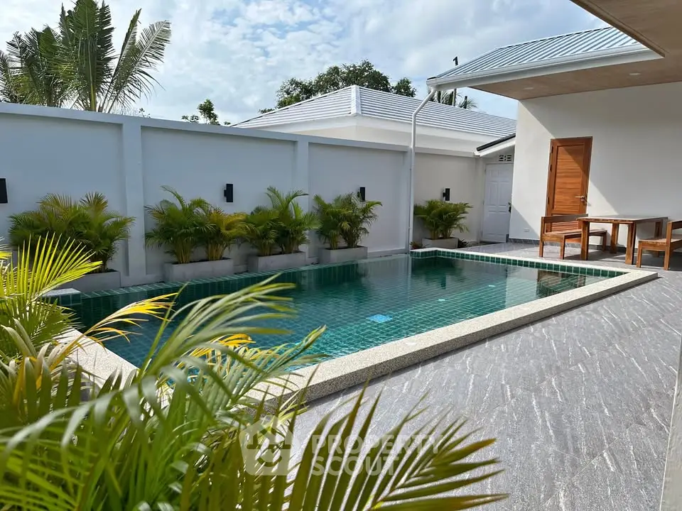 Luxurious private pool area with modern design and lush greenery, perfect for relaxation and entertainment.