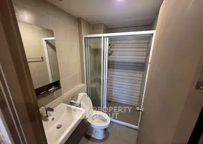 Modern bathroom with glass shower enclosure and sleek fixtures