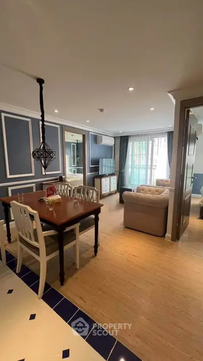 Charming open-plan living and dining area with elegant decor and ample natural light.