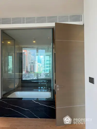 Luxurious bathroom with city view and modern bathtub in high-rise apartment