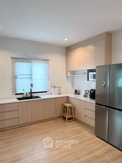 Modern kitchen with sleek cabinetry and stainless steel appliances in a bright, spacious layout.