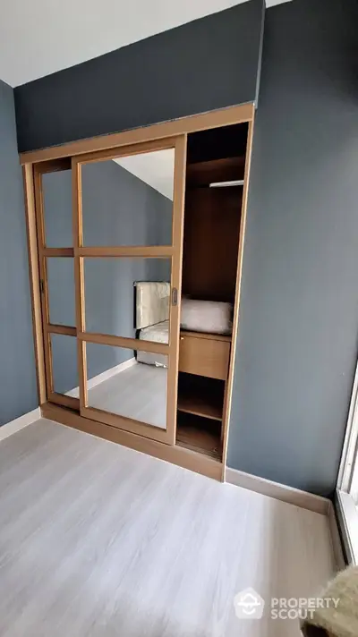 Modern bedroom with stylish built-in wardrobe and sleek sliding doors