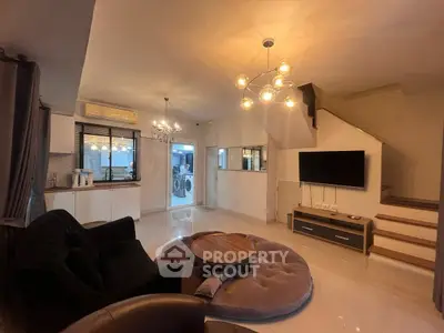 Modern living room with stylish lighting and open kitchen layout