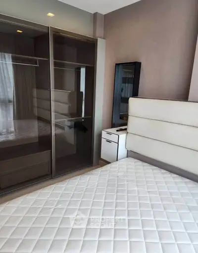 Modern bedroom with sleek wardrobe and stylish headboard in a contemporary apartment.