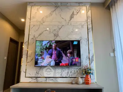 Luxurious living room with marble TV wall and elegant decor
