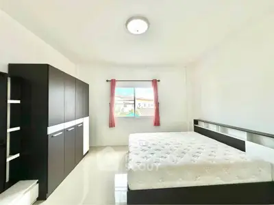 Spacious bedroom with modern furniture and natural light