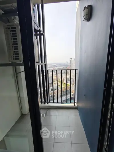 Compact balcony with city view in modern high-rise apartment