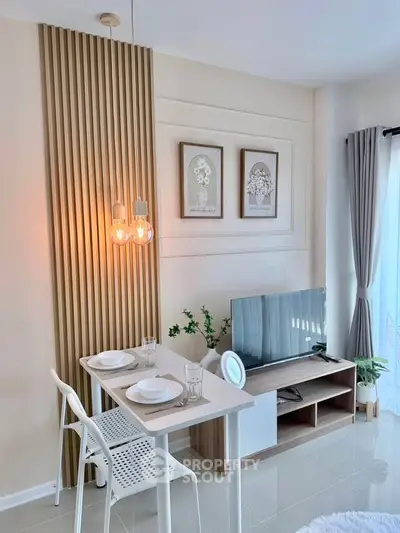 Modern living room with stylish decor, TV unit, and dining area in a cozy apartment setting.