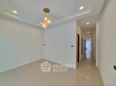 Spacious modern interior with elegant lighting and sleek tile flooring, perfect for contemporary living.