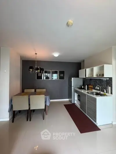 Modern open-layout kitchen and dining area with sleek design and stylish decor.