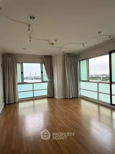 Spacious corner unit with panoramic city view and large windows.
