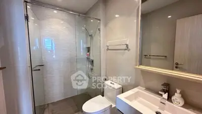 Modern bathroom with glass shower and sleek fixtures