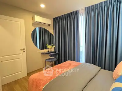Cozy bedroom with modern decor, featuring a large window, stylish curtains, and a comfortable bed.
