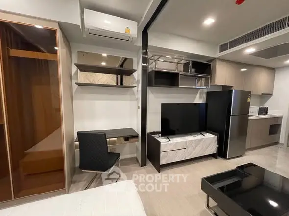 Modern studio apartment with sleek furniture and open kitchen layout