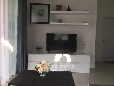 Modern living room with sleek TV stand and decorative shelves, perfect for stylish urban living.