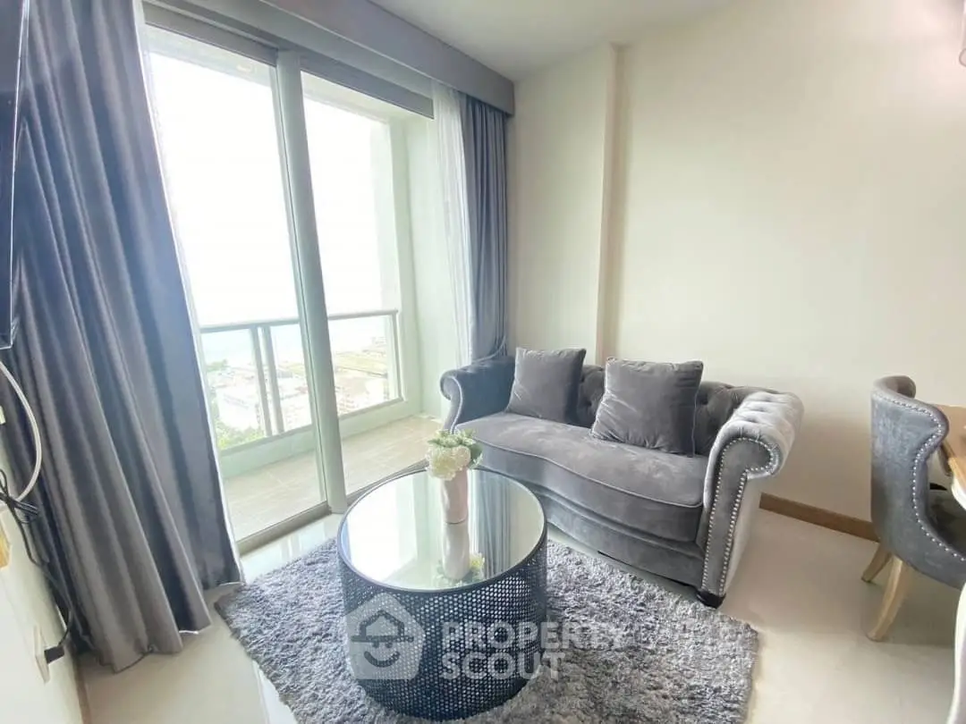 Luxurious living room with plush gray sofa and stunning balcony view