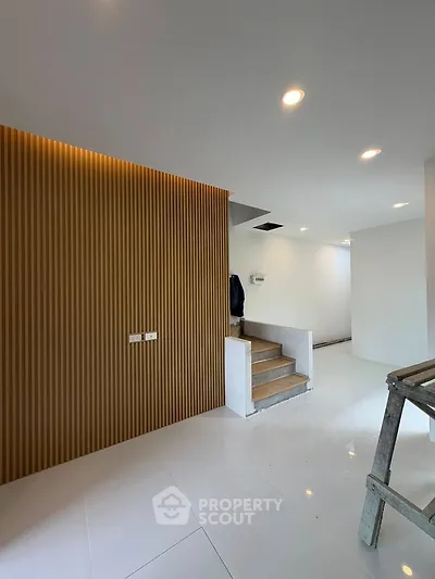 Modern interior with sleek staircase and stylish wood paneling
