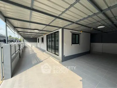 Spacious covered outdoor area with modern design and ample natural light.