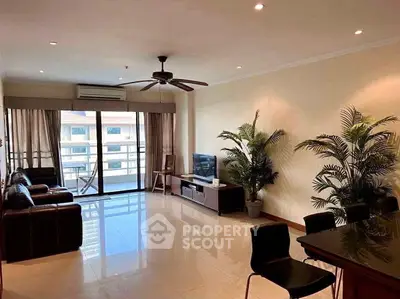 Spacious living room with modern decor and balcony view in luxury apartment.