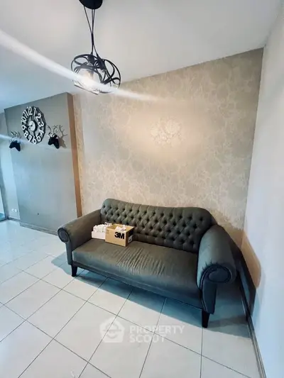 Stylish living room with elegant sofa and unique wall decor