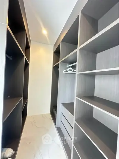 Spacious walk-in closet with modern shelving and ample storage space.