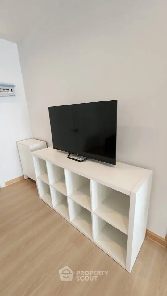 Modern living room with sleek TV stand and flat-screen TV