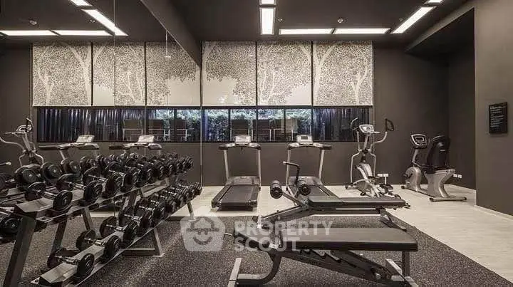 Modern gym with state-of-the-art equipment and stylish decor in a luxury residential building.
