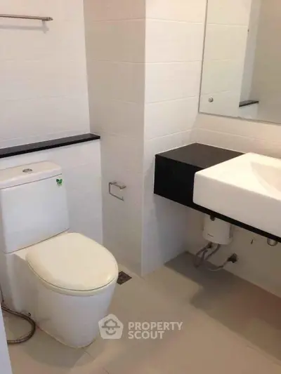 Modern bathroom with sleek fixtures and minimalist design in a contemporary apartment.