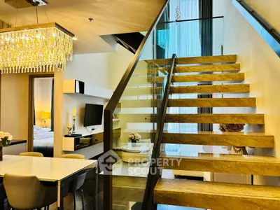 Luxurious modern interior with elegant staircase and chandelier, perfect for upscale living.