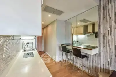 Modern kitchen with sleek design and breakfast bar in a stylish apartment.