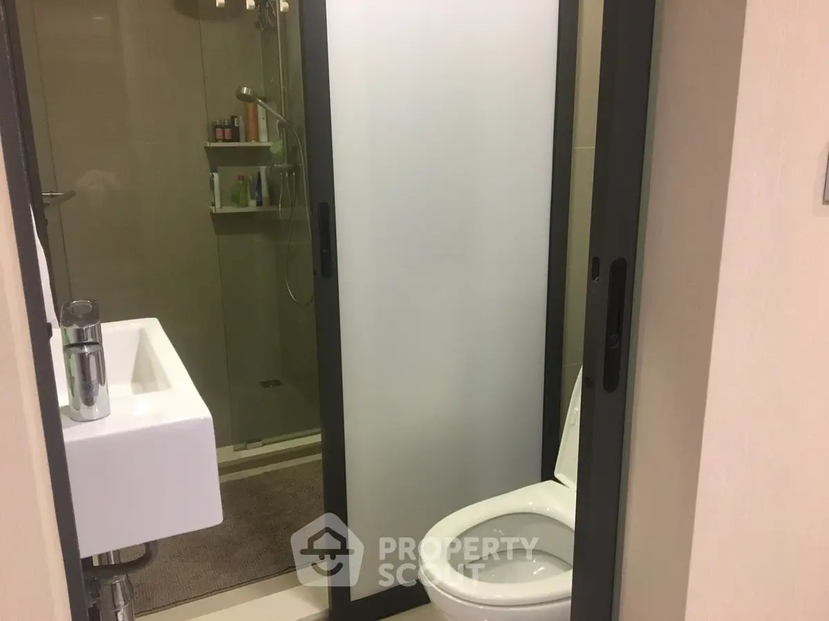 Modern bathroom with sleek shower and compact sink design