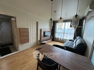 Modern living room with stylish furniture and large windows offering city views.