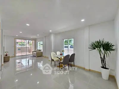 Spacious modern living room with glossy floors and large windows for natural light.