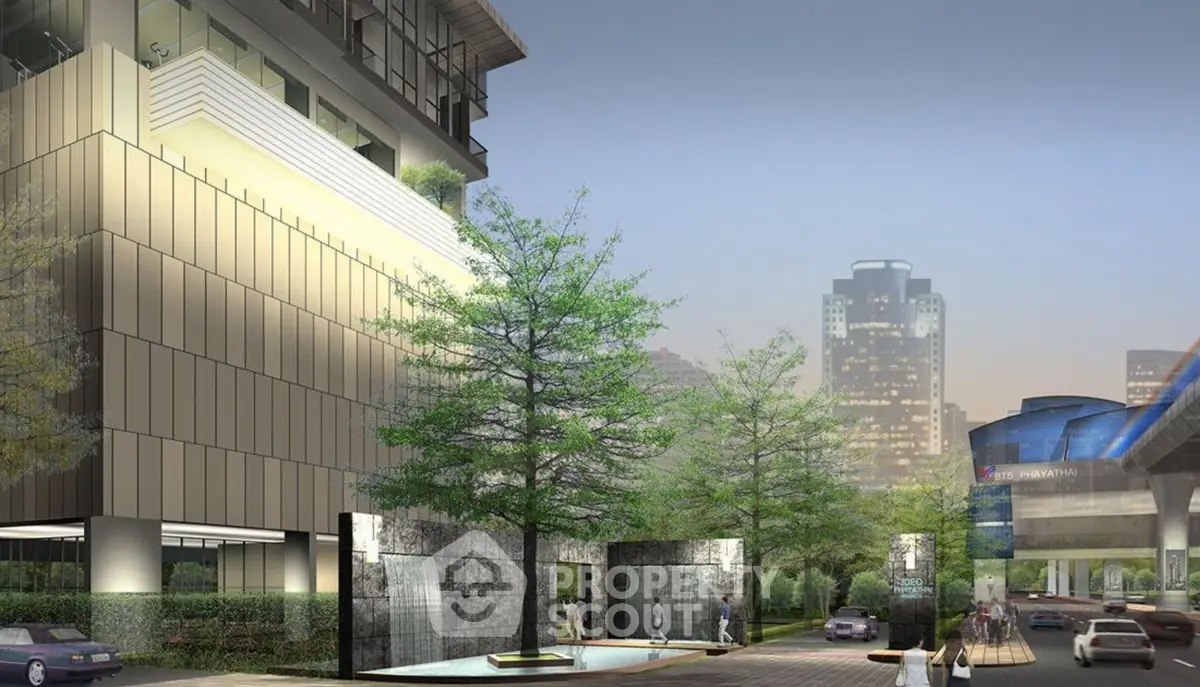 Modern urban building exterior with lush landscaping and water features in a vibrant city setting.