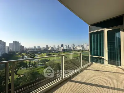 Spacious balcony with stunning cityscape and golf course view, perfect for relaxation.