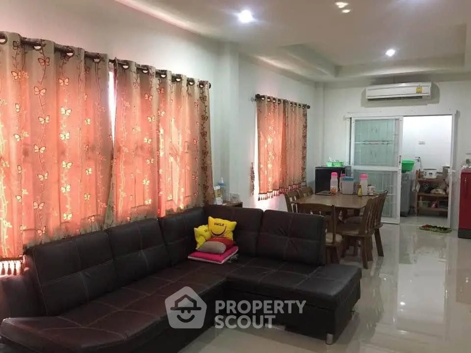 Spacious living room with modern furniture and dining area in open layout