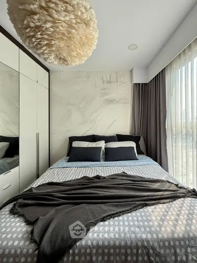 Modern bedroom with stylish decor and large window for natural light
