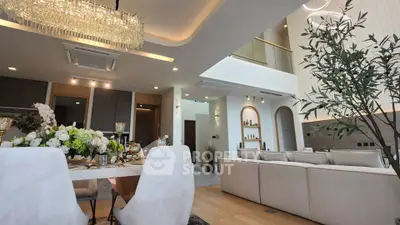 Luxurious open-plan living and dining area with elegant decor and high ceilings