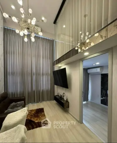 Luxurious modern living room with high ceilings and elegant chandelier