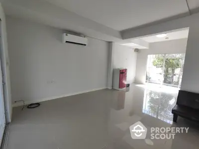 Spacious modern living room with air conditioning and glossy tiled floors